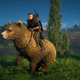 Eivor riding a bear outside in the sunlight.